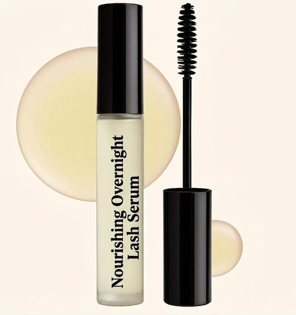 Nourishing Overnight Lash Serum in a frosted glass bottle with a black cap and wand applicator, beside golden oil droplets